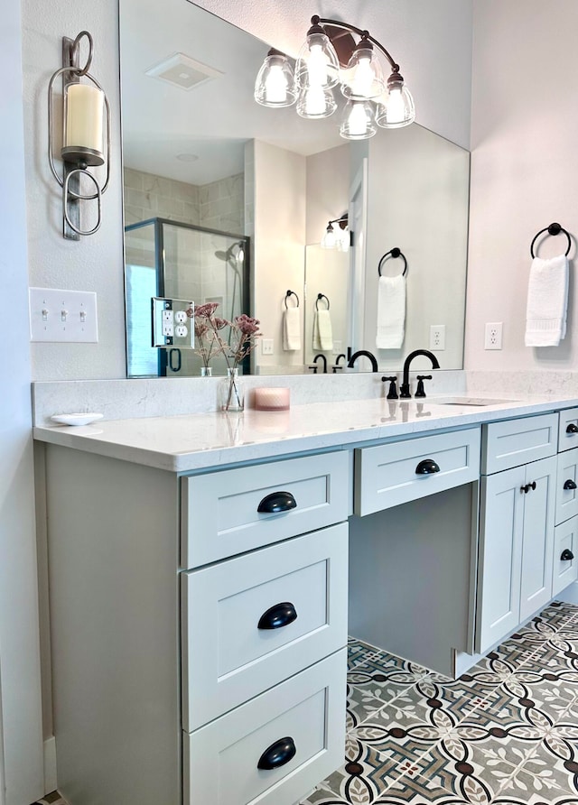 bathroom with tile patterned flooring, vanity, and a shower with shower door