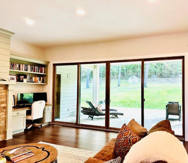 interior space featuring built in desk, dark hardwood / wood-style floors, and a healthy amount of sunlight