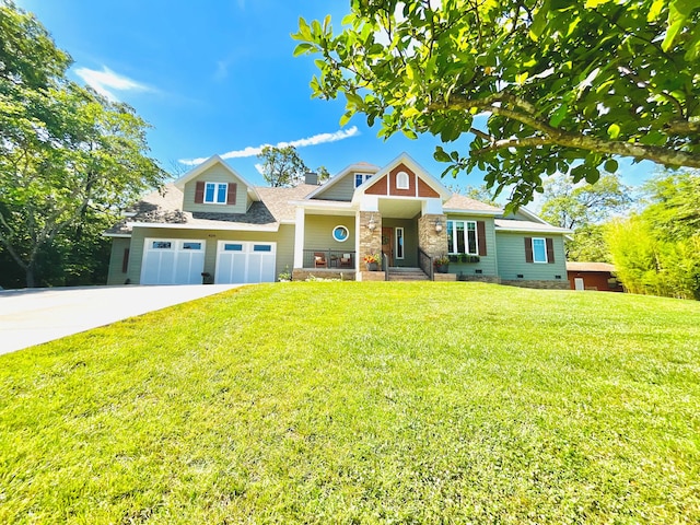 craftsman inspired home featuring a front yard and a garage