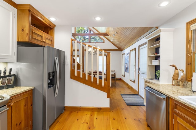 kitchen featuring light stone countertops, wooden ceiling, light hardwood / wood-style floors, vaulted ceiling, and appliances with stainless steel finishes