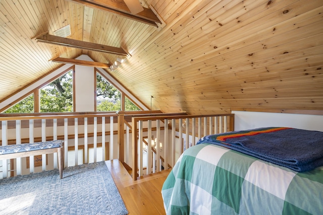 bedroom featuring vaulted ceiling with beams, wooden ceiling, and light hardwood / wood-style floors