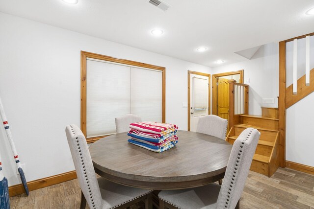 dining space with light hardwood / wood-style floors