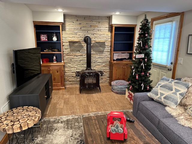 living room with hardwood / wood-style flooring and a wood stove