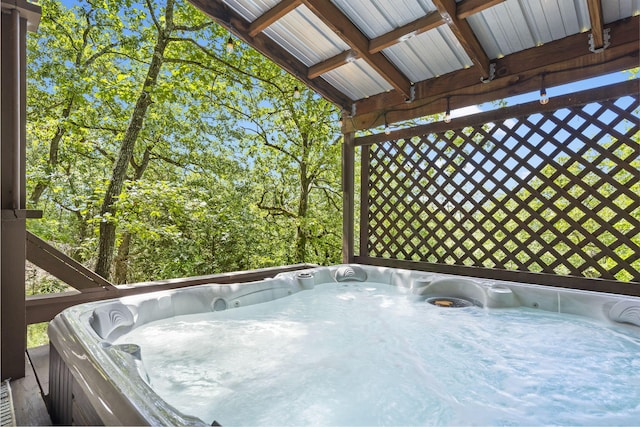 wooden terrace with a hot tub