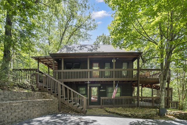 log-style house with a wooden deck