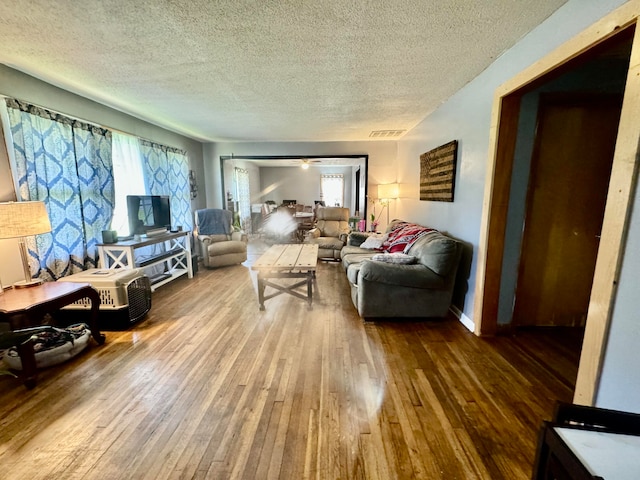 living room with hardwood / wood-style flooring and a textured ceiling