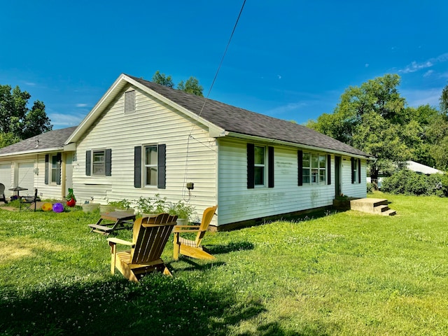 rear view of property with a yard