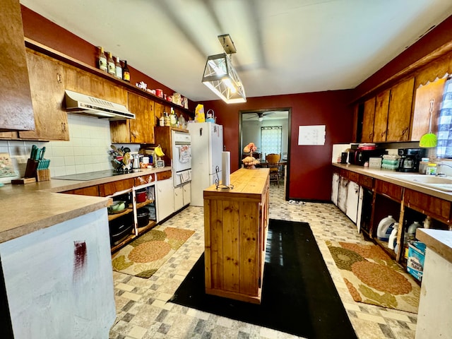 kitchen with ceiling fan, decorative backsplash, white appliances, sink, and extractor fan