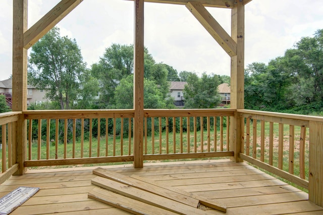 wooden terrace with a lawn