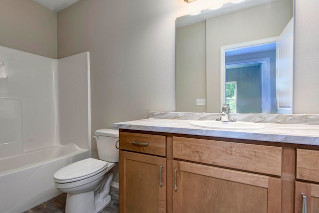 full bathroom with vanity, toilet,  shower combination, and wood-type flooring