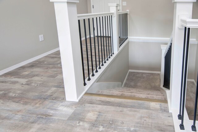 stairs with wood-type flooring