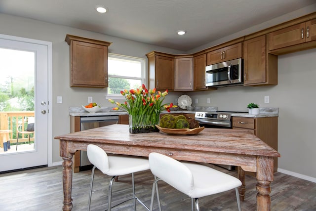 kitchen with stainless steel appliances and light hardwood / wood-style floors