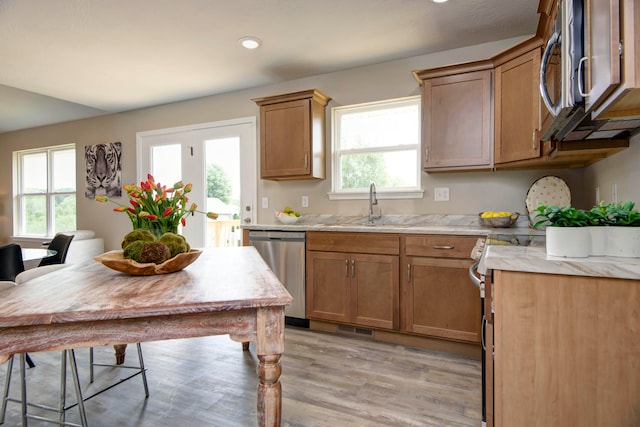 kitchen with sink, light hardwood / wood-style floors, and stainless steel appliances