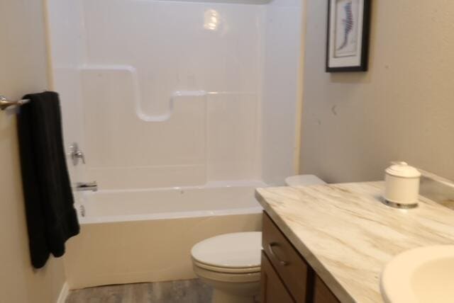 full bathroom with toilet, vanity, and shower / bathtub combination