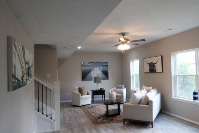 living room featuring hardwood / wood-style flooring and ceiling fan