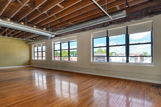 unfurnished room with hardwood / wood-style floors