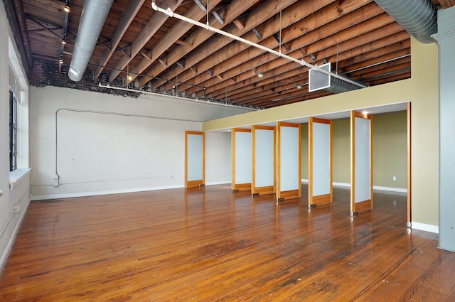 basement with hardwood / wood-style floors