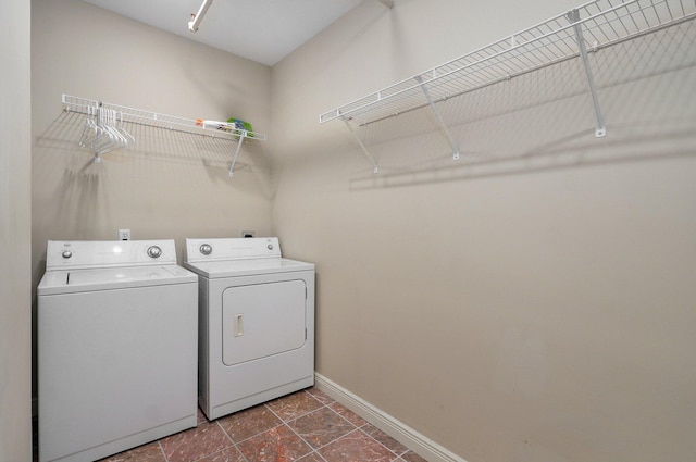 clothes washing area with washing machine and clothes dryer