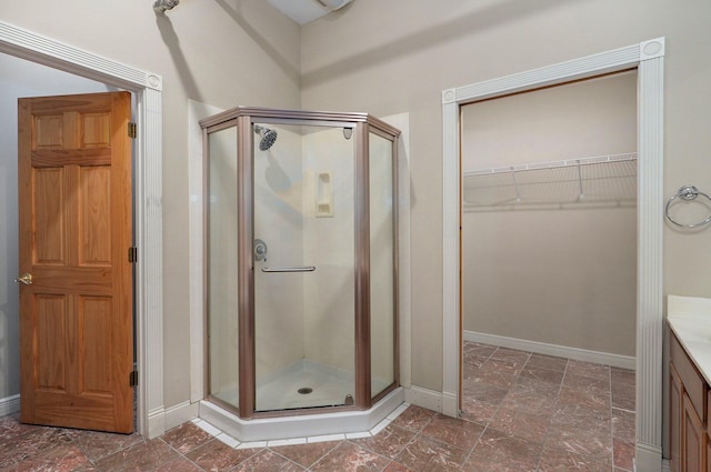 bathroom with walk in shower and vanity