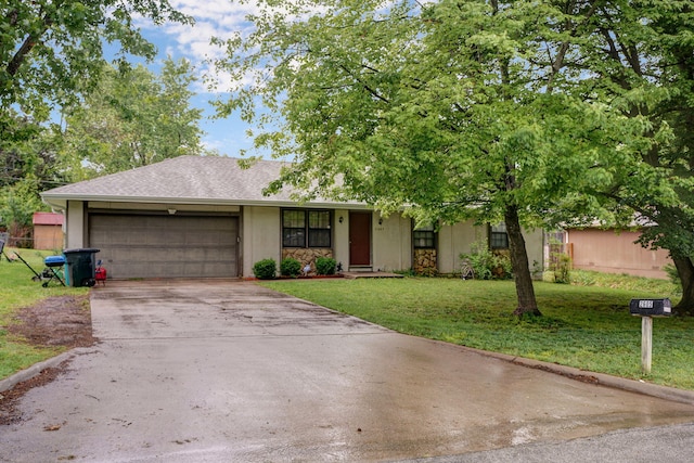 ranch-style house featuring a garage and a front lawn