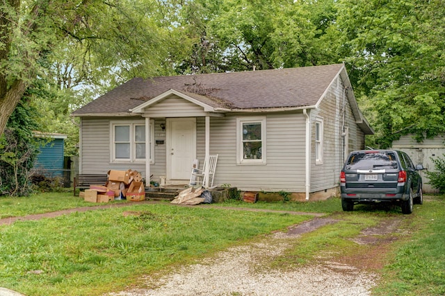 bungalow-style home with a front yard