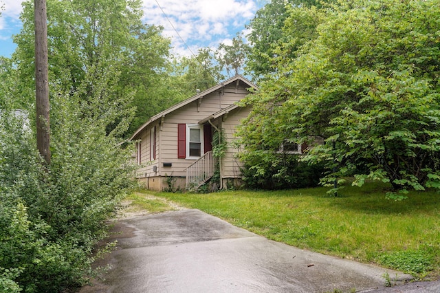 view of side of home with a lawn