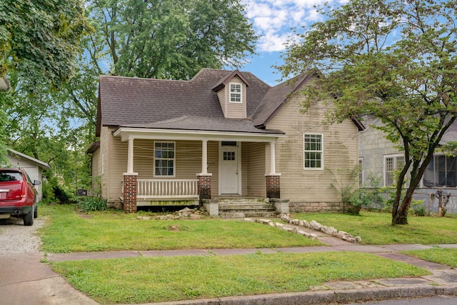 view of front of home featuring a front yard and a porch