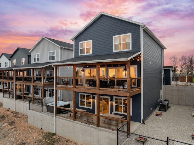 back house at dusk with a balcony