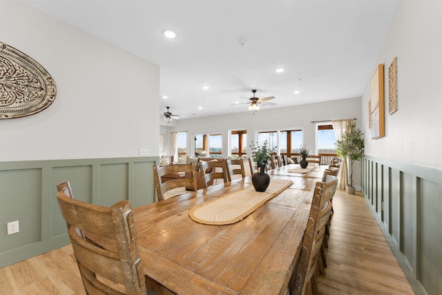 dining space featuring ceiling fan and light wood-type flooring