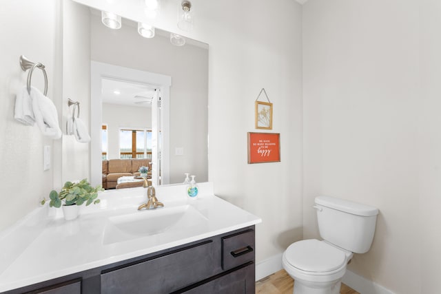 bathroom featuring vanity, hardwood / wood-style floors, and toilet