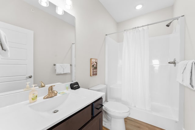 bathroom with curtained shower, hardwood / wood-style flooring, vanity, and toilet