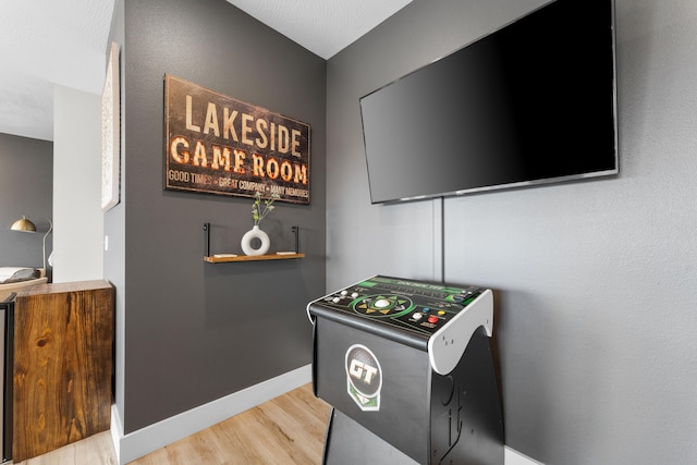 game room with light hardwood / wood-style flooring