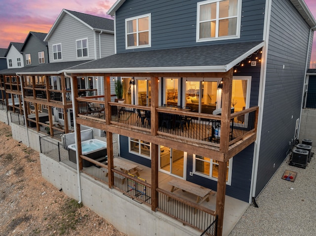 back house at dusk with a patio