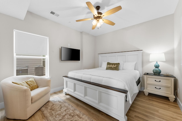 bedroom with light hardwood / wood-style flooring and ceiling fan