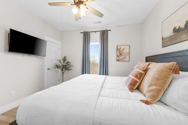 bedroom with ceiling fan and hardwood / wood-style flooring