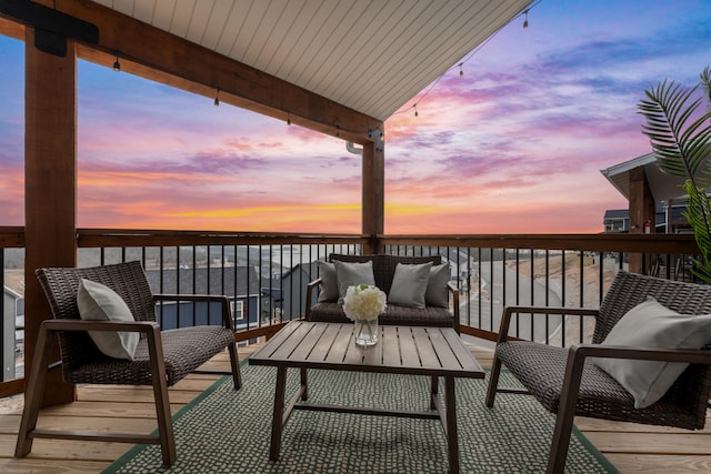 balcony at dusk with a deck with water view