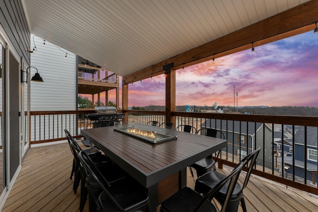 deck at dusk with area for grilling