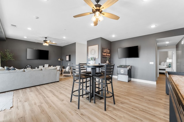 dining area featuring light hardwood / wood-style flooring and ceiling fan