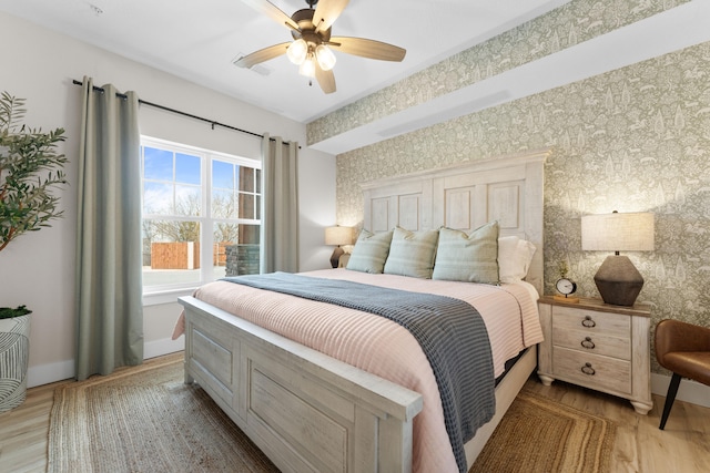 bedroom with light hardwood / wood-style flooring and ceiling fan