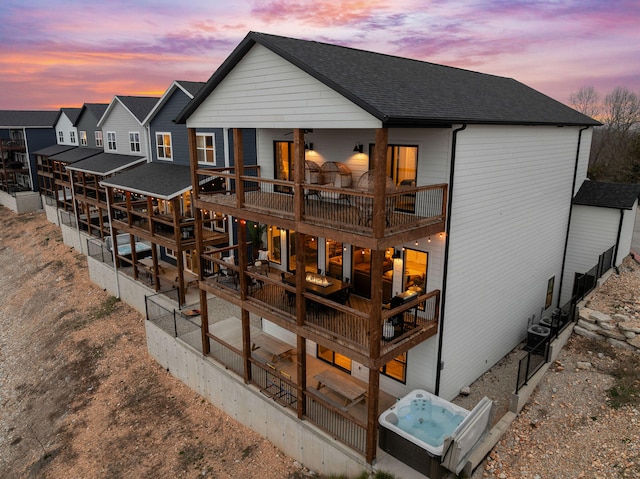 view of back house at dusk