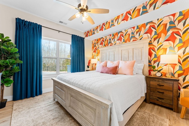 bedroom with light hardwood / wood-style flooring and ceiling fan