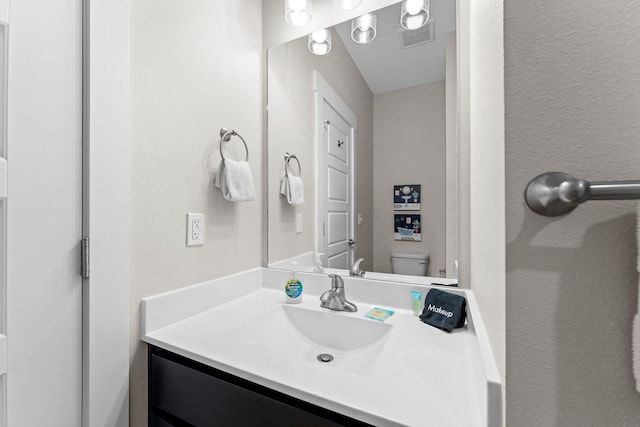 bathroom with vanity and toilet