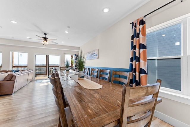 dining area with light hardwood / wood-style floors and ceiling fan