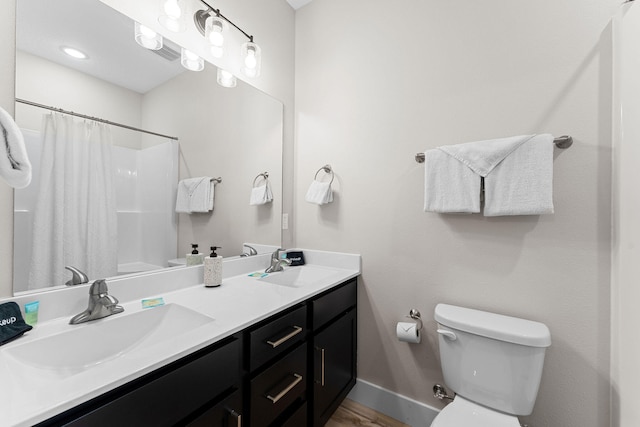 bathroom with walk in shower, vanity, toilet, and hardwood / wood-style flooring