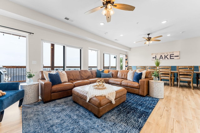 living room featuring ceiling fan and hardwood / wood-style floors