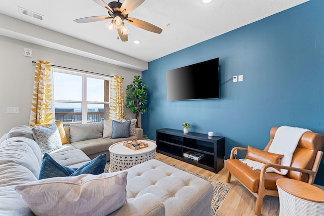 living room with ceiling fan and hardwood / wood-style floors