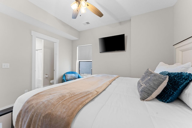 bedroom featuring ceiling fan and ensuite bath