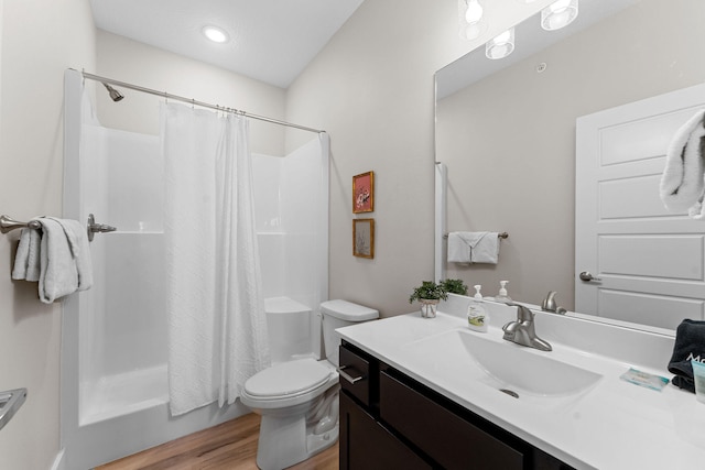 full bathroom featuring shower / tub combo, hardwood / wood-style floors, vanity, and toilet