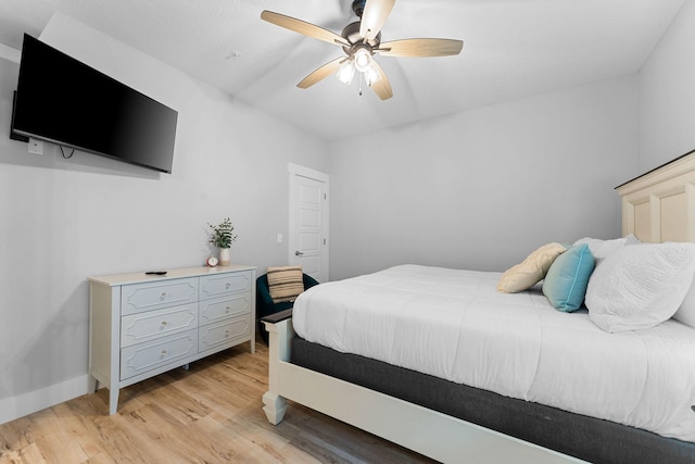 bedroom with ceiling fan and light hardwood / wood-style flooring