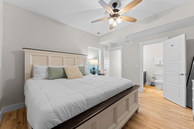 bedroom with ensuite bath, light hardwood / wood-style flooring, and ceiling fan